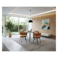 Square dining table with brown chairs in a bright dining room