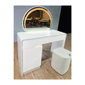White dressing table with arched mirror glowing warm yellow