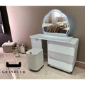 White dressing table with cloud-shaped mirror beside a wall