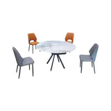 Round white stone-patterned table with grey and tan chairs