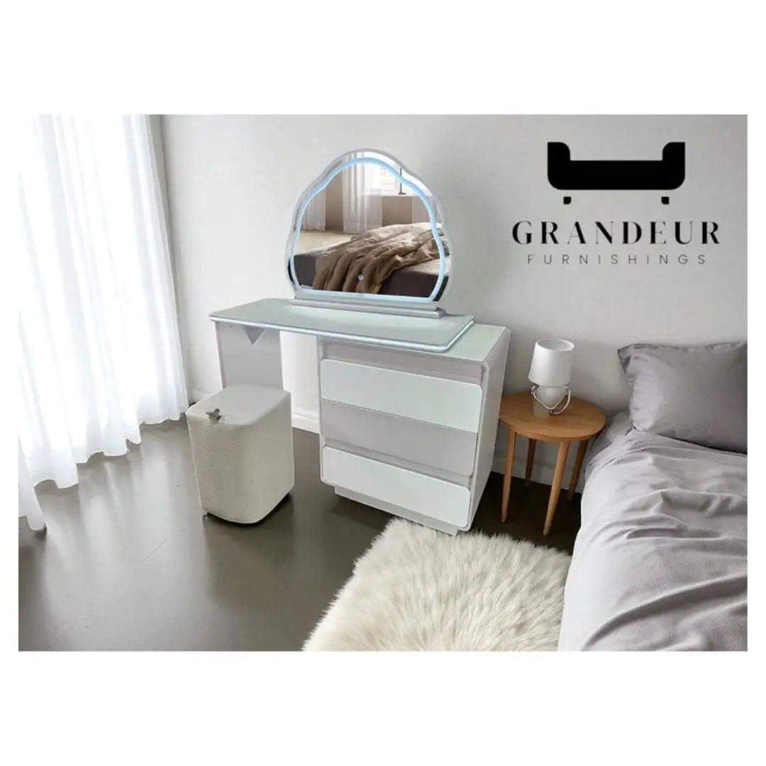 White dressing table with illuminated cloud-shaped mirror in a bedroom