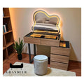 Wood-look dressing table with glass top and cloud-shaped mirror in a room