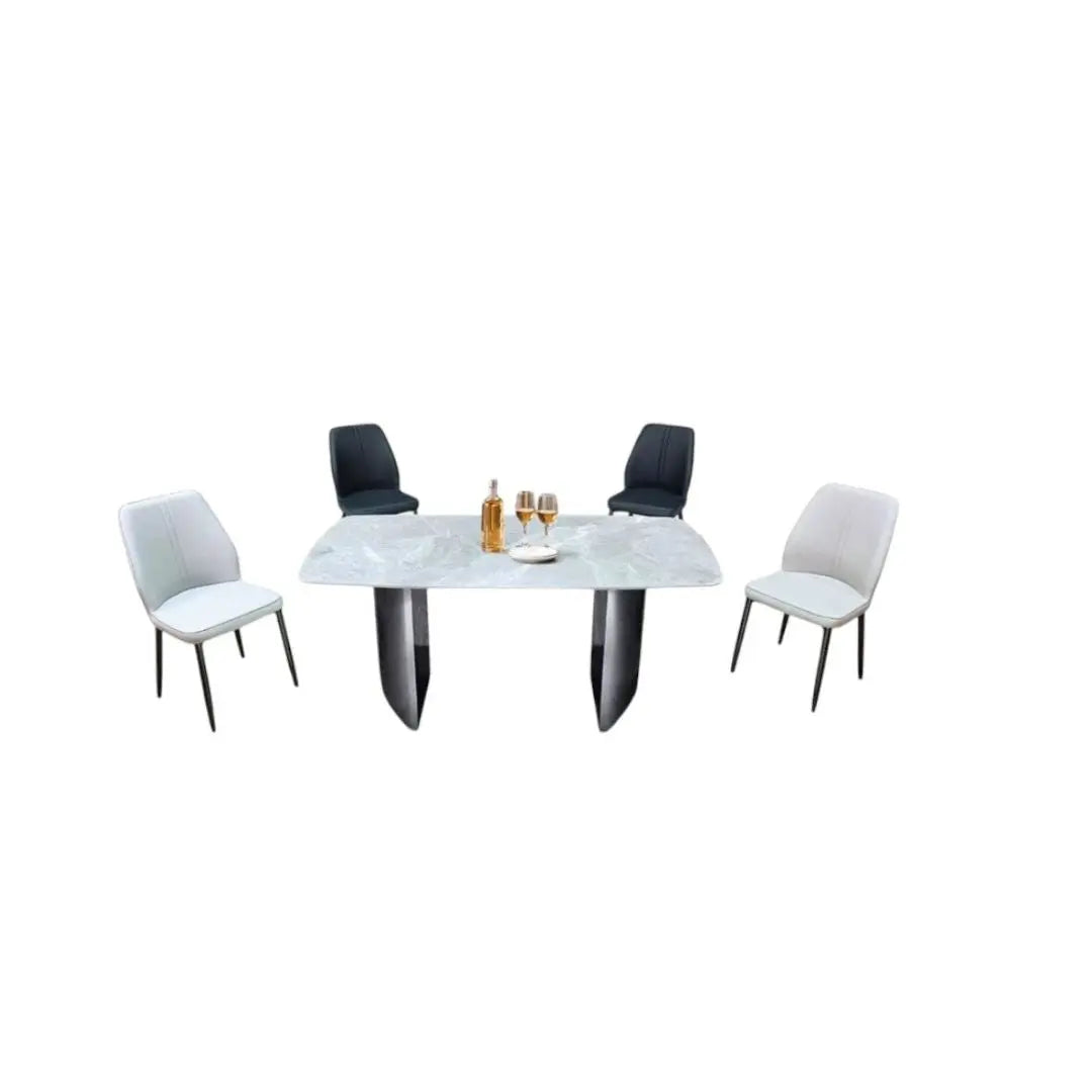 White stone-patterned dining table with black and beige chairs, angled view