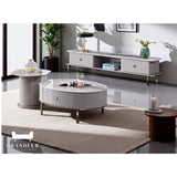 Grey TV console, oval coffee table and round side table in a living room
