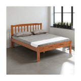 Wooden bed with vertical slatted headboard and grey bedding beside a window