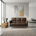 Brown Axis sofa beside a bright window