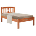 Cherry-coloured wooden bed frame with vertical slatted headboard and bedding