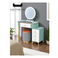 Green and white dressing table with right drawers beside a window