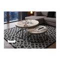 Brown stone-patterned round nesting tables beside a sofa