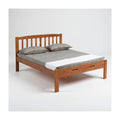 Wooden bed with vertical slatted headboard and grey bedding
