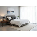 Dreamster Providence mattress and grey bed frame in a bedroom