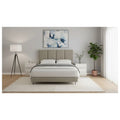 Beige upholstered bed with panelled headboard, front view