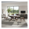 Dark wood dining table and slatted chairs in a living space
