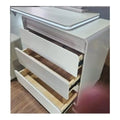 White dressing table with three storage drawers pulled open