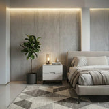 White bedside table beside a bed in a bedroom