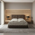 Brown upholstered bed, front view against a wood wall