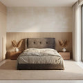 Dark grey tufted bed, front view against a wood panel wall