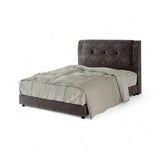 Dark grey upholstered bed with deep button-tufted headboard