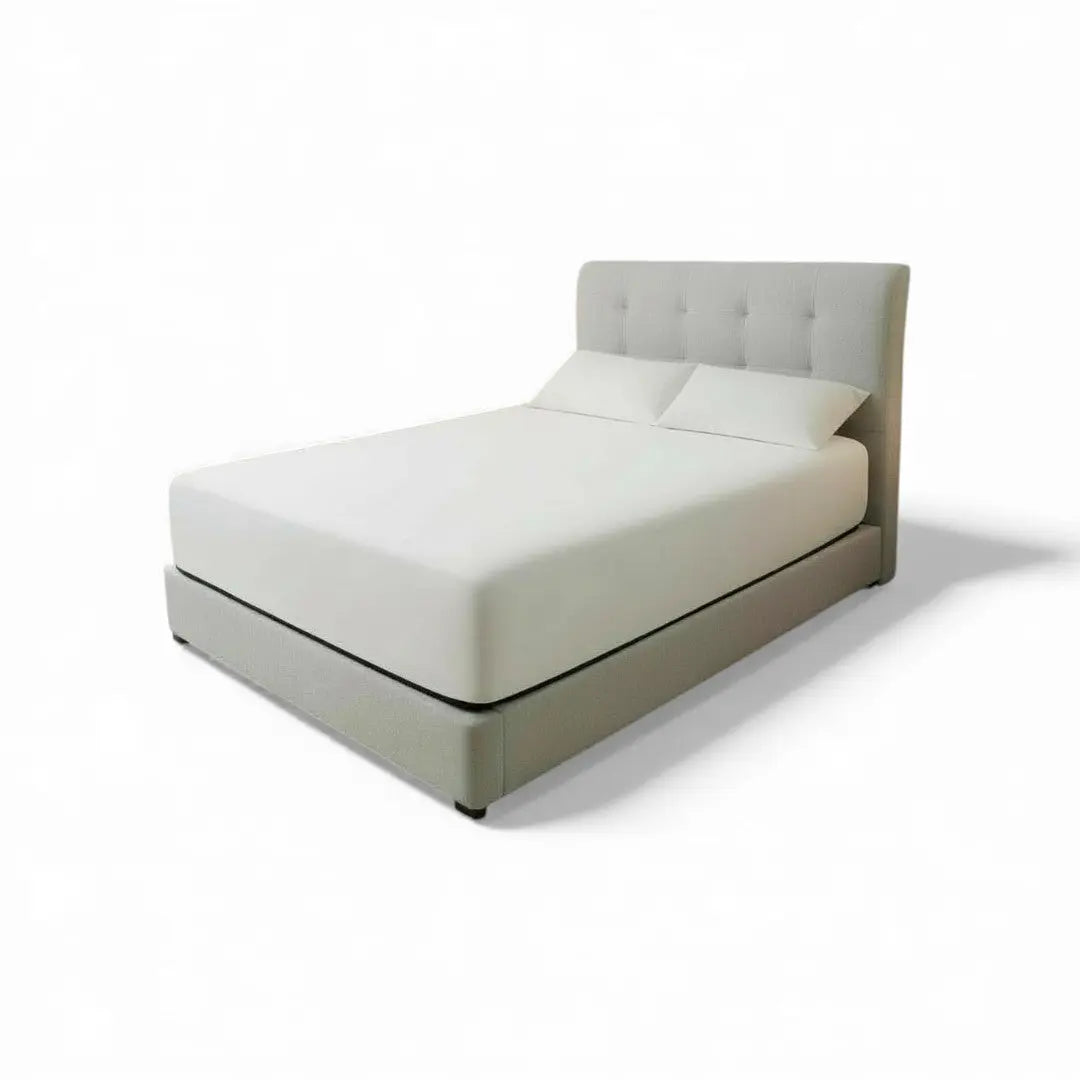 Pale upholstered Elancé bed with button-tufted headboard