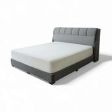 Grey Olera upholstered bed with cushioned headboard and winged sides